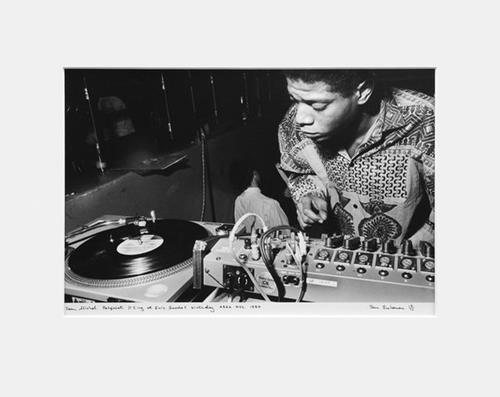 Jean-Michel Basquiat DJing at Eric Goode’s birthday, AREA, NYC, 1984 (First Edition) by Ben Buchanan